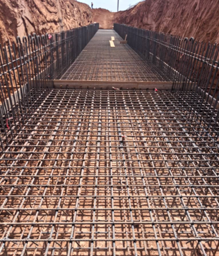 Pamicor Burkina site team placing reinforced concrete on the TSF diversion channel at Houndé