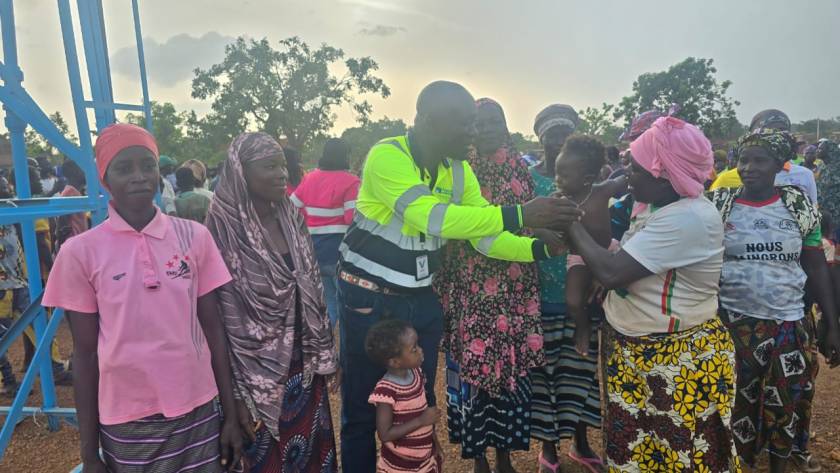 Residents of Dangona, Burkina Faso, gather at their new borehole during its inauguration